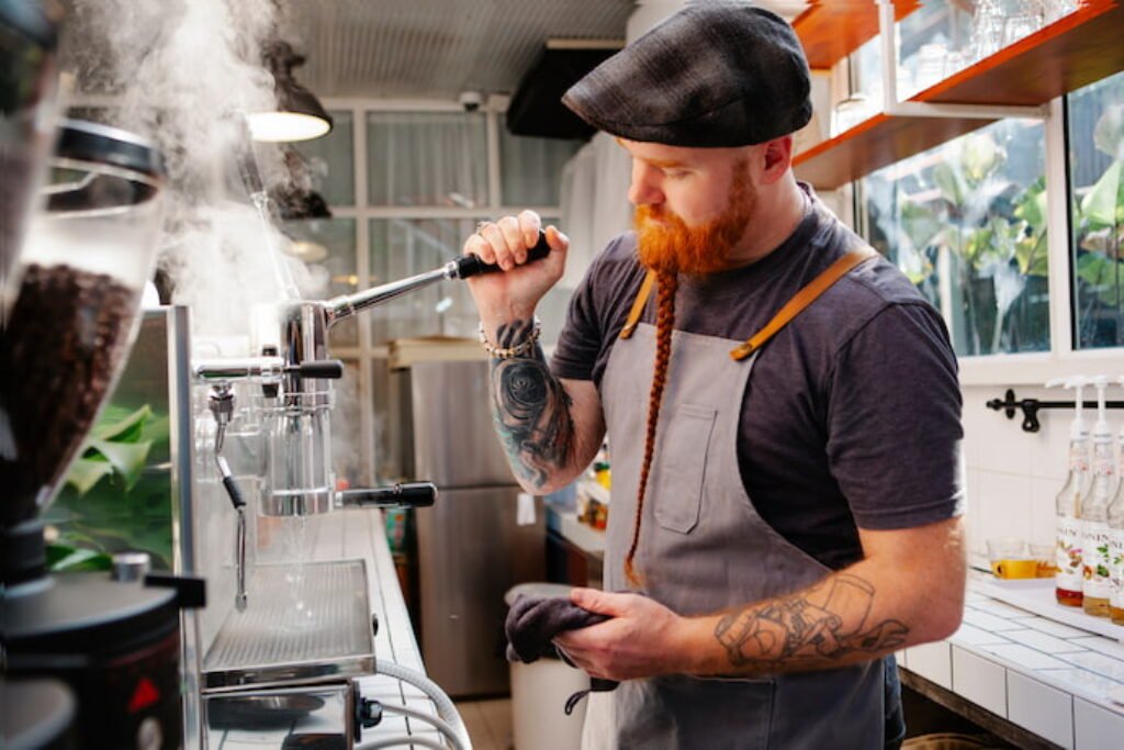 Barista servindo uma xícara de café.