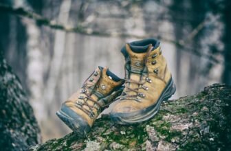 Um par de botas em cima de uma pedra grande em uma montanha