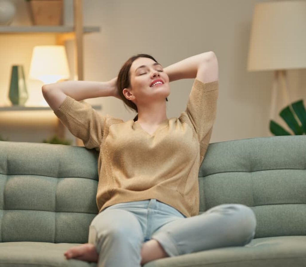 Uma mulher relaxando em um sofá.