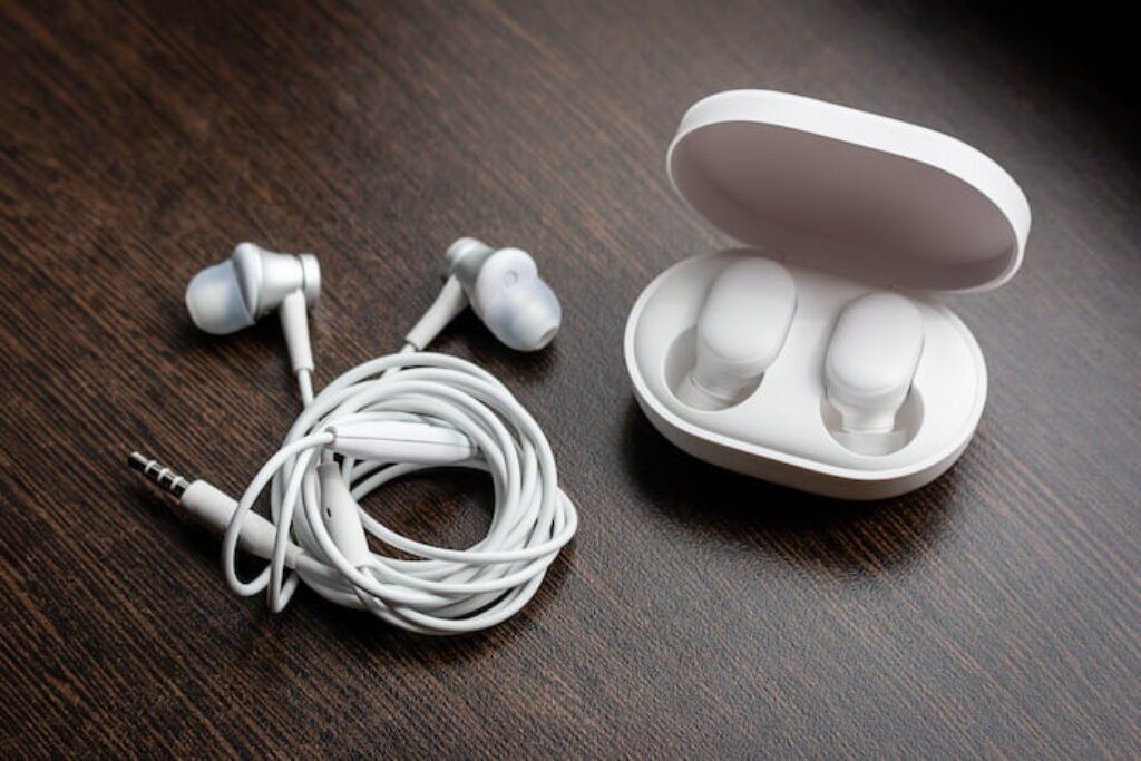 Fone de ouvido enrolado ao lado de uma case.